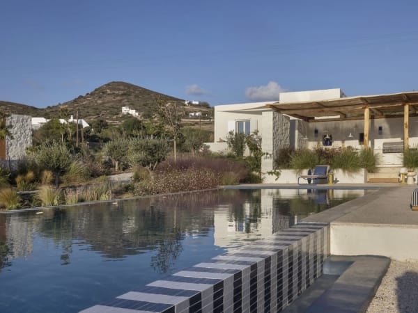 Steps Away's serene, 14.5m-long  infinity pool with the al fresco dining area and kitchen behind.