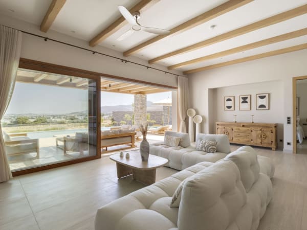 The bright living room of Villa I, with its wall of sliding glass doors and its sea views.