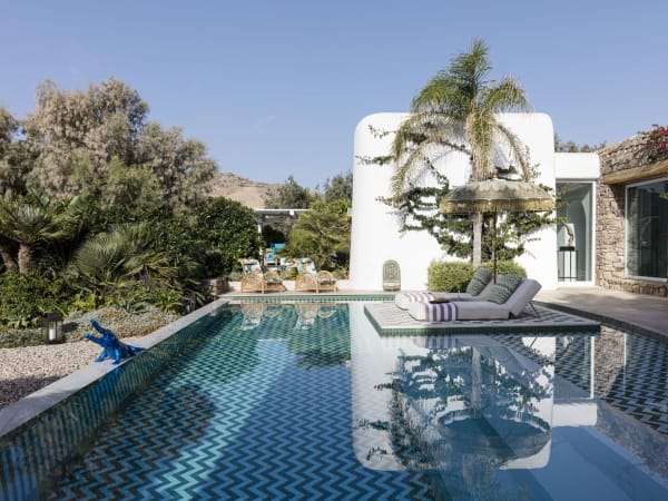 The serene, beautifully designed pool outside Villa Theros's main house.