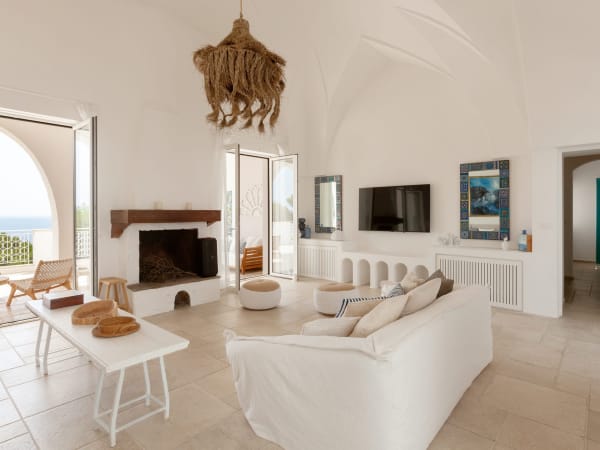 Blu Melia's bright, elegant living area, with its sea views and terrace access.
