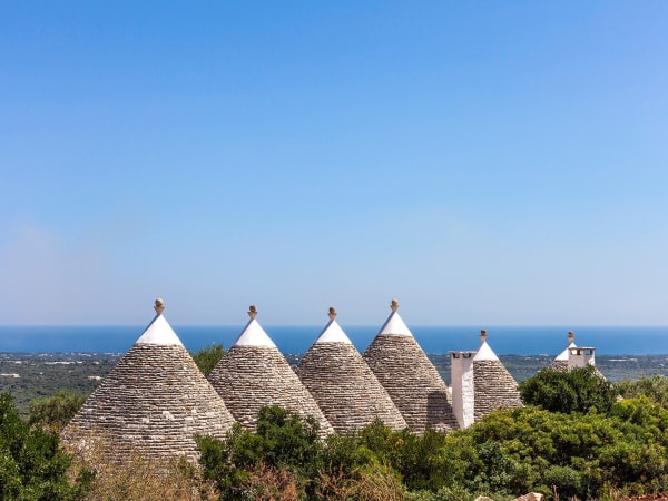 The trulli are surrounded by beautifully-tended gardens and lawns.