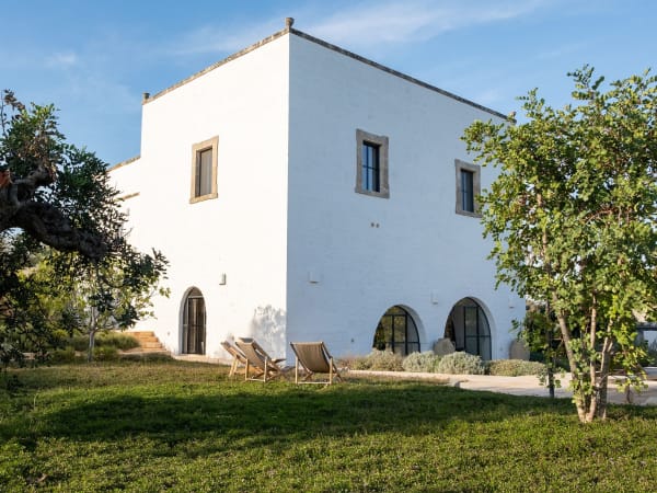 Masseria Donnagnora's handsome façade rising from the surrounding walled gardens.