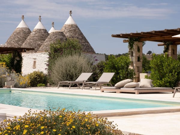 Four of OttoConi's eight trulli cones rising above the pool.