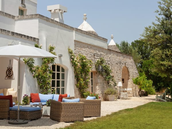 The elegant arched French doors that line the façade of Trullo Rosmarino.
