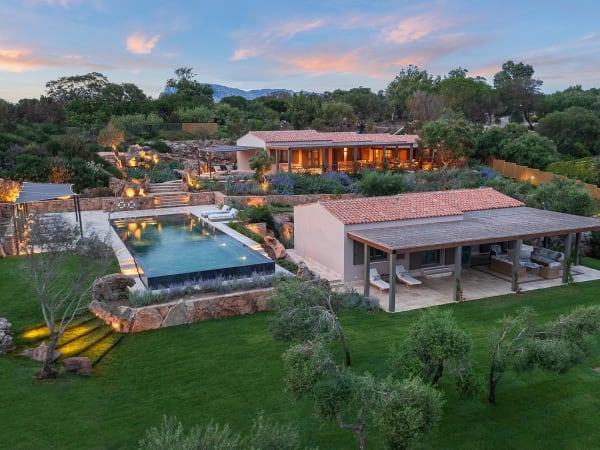 The main house, guesthouse and infinity pool of Salinedda Six are enveloped in manicured gardens.