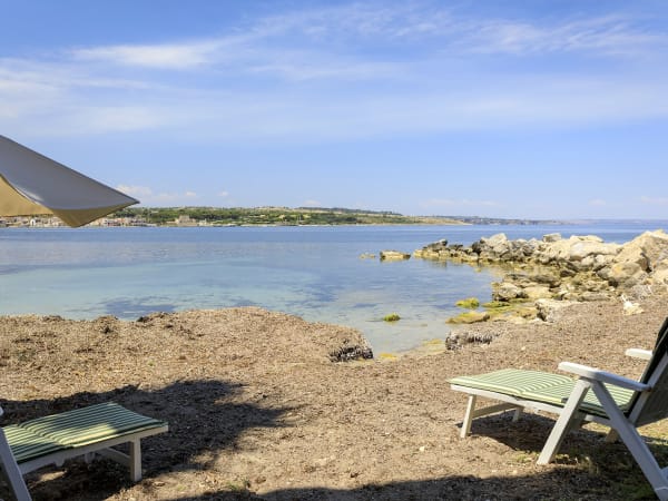 Soaking up the sun and the views on the seafront outside Ammare.