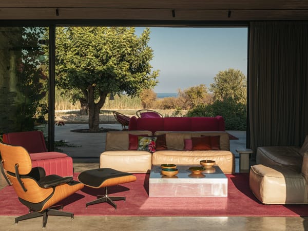 Walls of sliding glass doors seamlessly fuse indoor and outdoor areas.