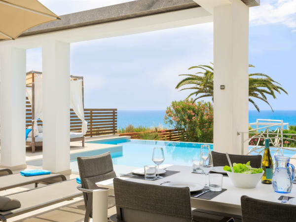The kitchen opens out to the al fresco dining area, which has views of the sea.