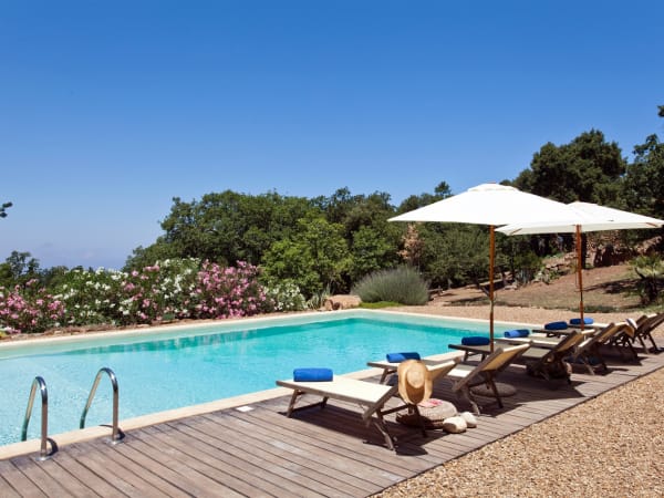 Loungers in the shade beside the pool.