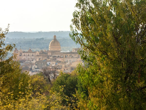 The magnificent dome of Noto's cathedral seen from near the pool.