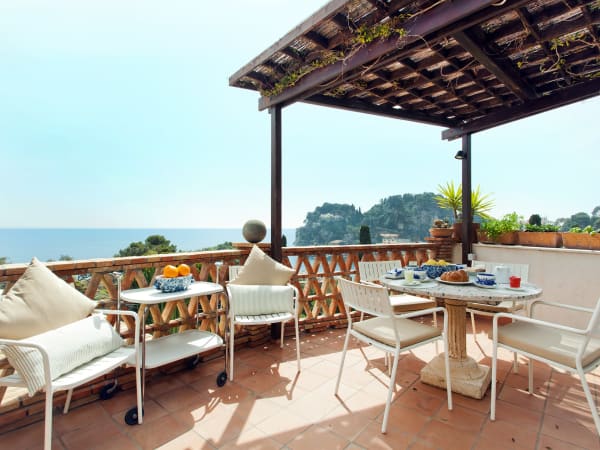 The living area leads onto the smaller breakfast terrace.