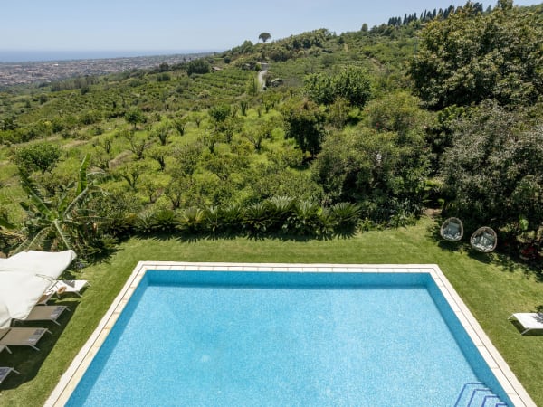 Ortensia's panoramic swimming pool is set amongst pristine greenery.