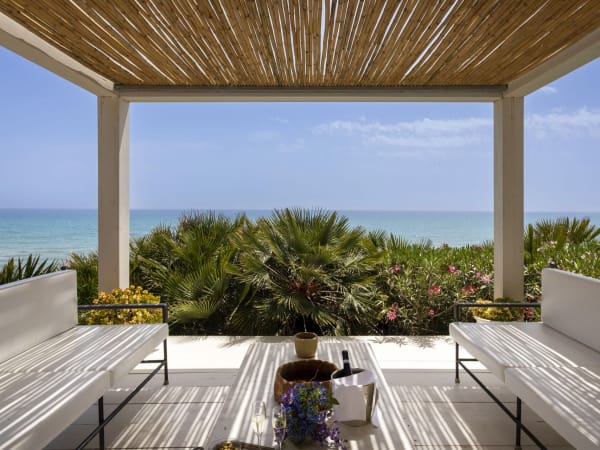The elegant shady pergola in front of the house is a relaxing spot from which to take in the sea views.