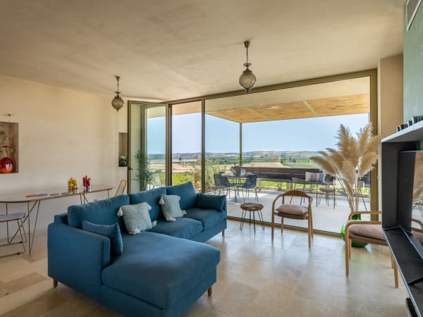 The open-plan communal area with its wall of glass, views and terrace access.