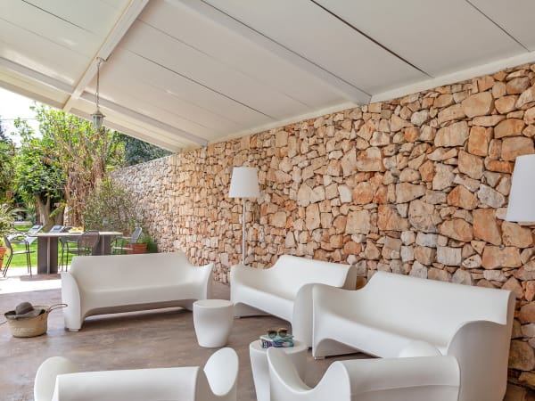 The shady terrace by the pool, with plenty of space for everyone.
