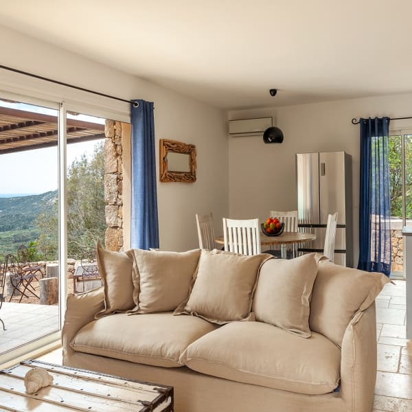 The bright, comfortably furnished open-plan living, dining and kitchen area.