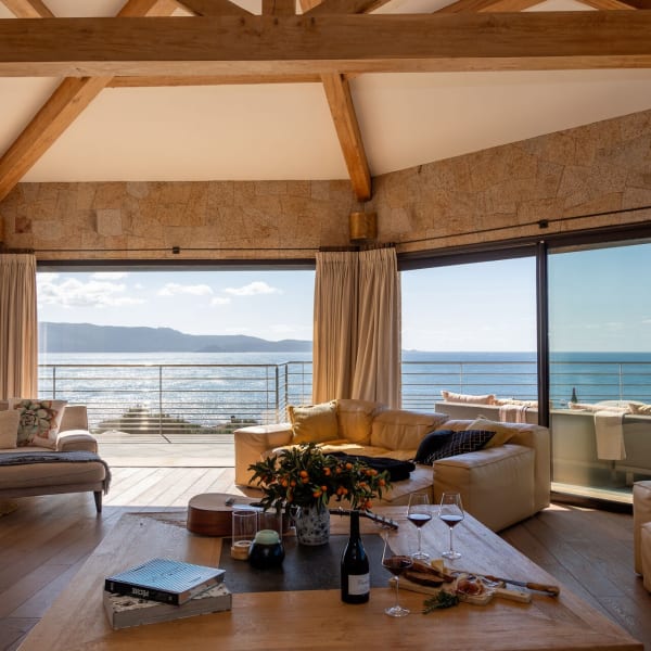 The spacious, airy living area on the upper floor with its sea views and banks of sliding doors.
