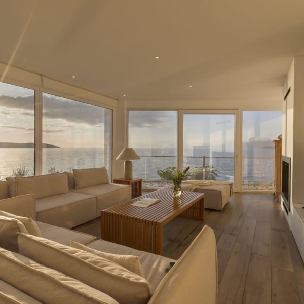 Walls of windows and glass doors make the very most of the unforgettable sea views.
