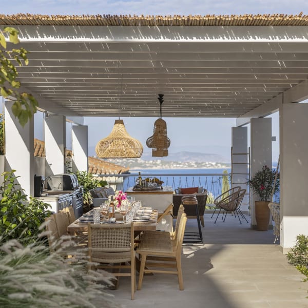 Catrine's gorgeous, shady al fresco dining area and kitchen with its views out to sea.