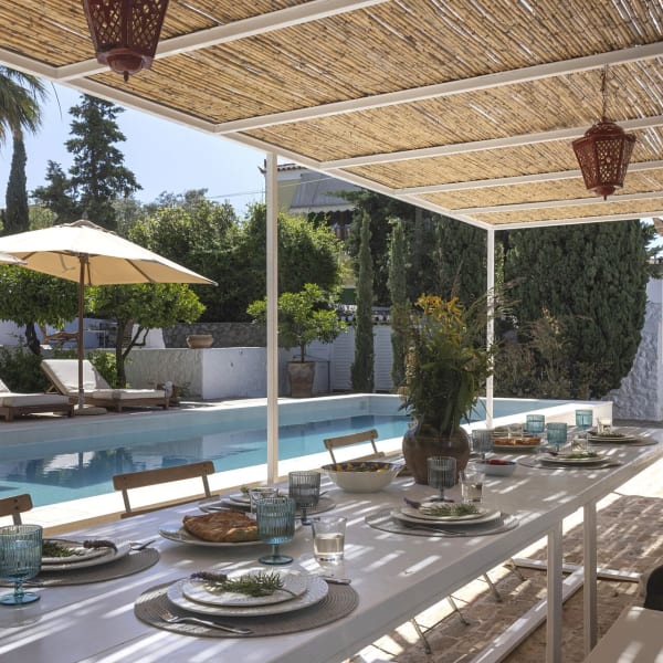 The al fresco dining area outside the pool house is perfect for convivial moments.