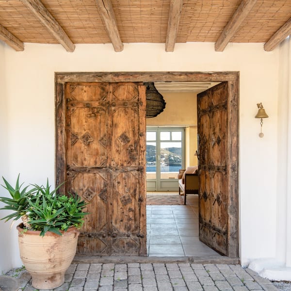 A pair of venerable wooden doors welcome guests to the main house.