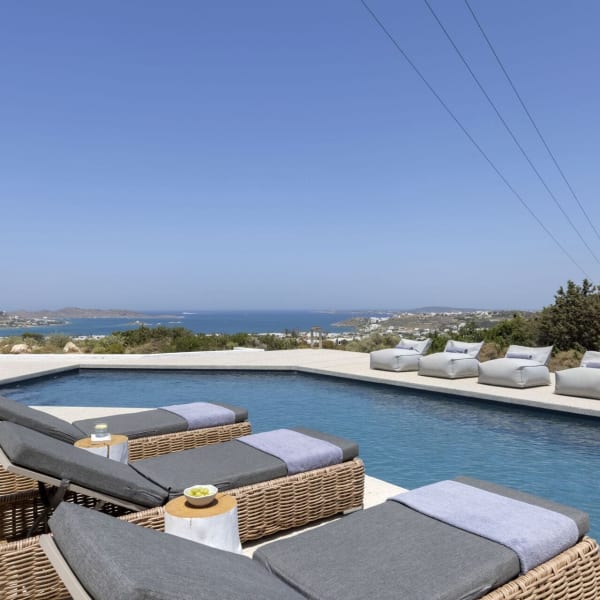 Pura Vida's irresistible, 15m-long angular pool with its views out to sea.Flanking the pool is a large shaded area with dining table, built-in seating, a bar and a barbecue.