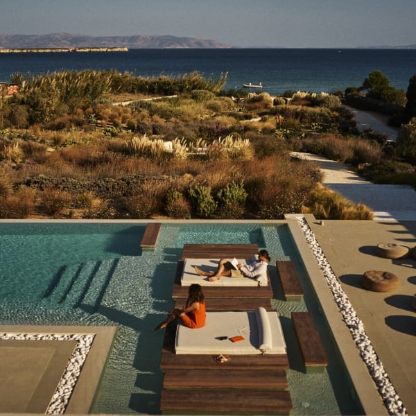 Santhia's "floating" wooden daybeds in the shallow end of the pool, and the views out to sea.