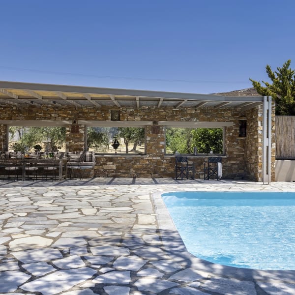 The shaded sitting and dining area by the pool.