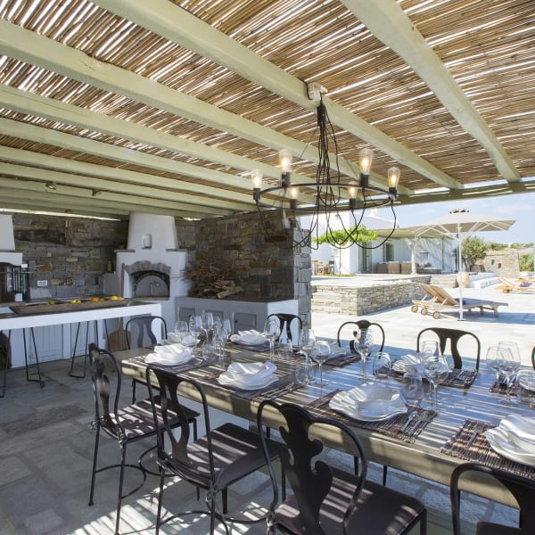 The shady al fresco kitchen and dining area, complete with pizza oven and barbecue.