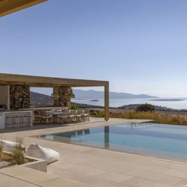 Xasteria's serene, 15m-long infinity pool and its al fresco bar and dining area.