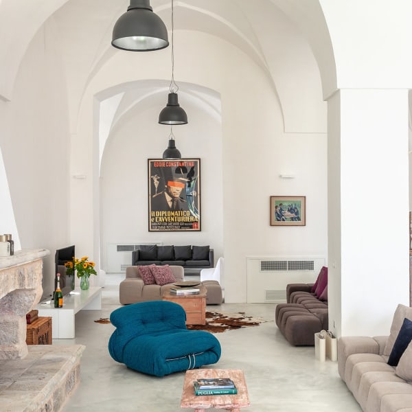A cosy sitting area around the fireplace in the open-plan communal space.