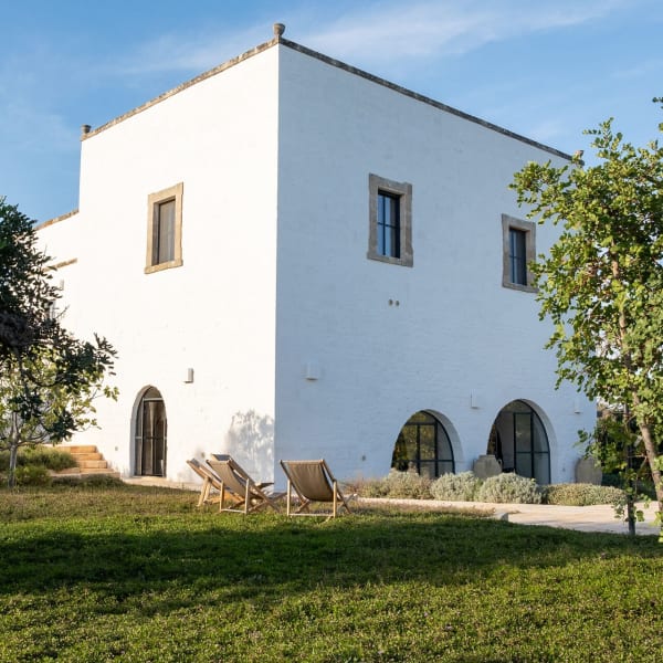 Masseria Donnagnora's handsome façade rising from the surrounding walled gardens.