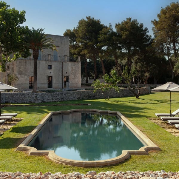 Villa Lorans's irresistible pool enveloped by manicured verdant lawns.