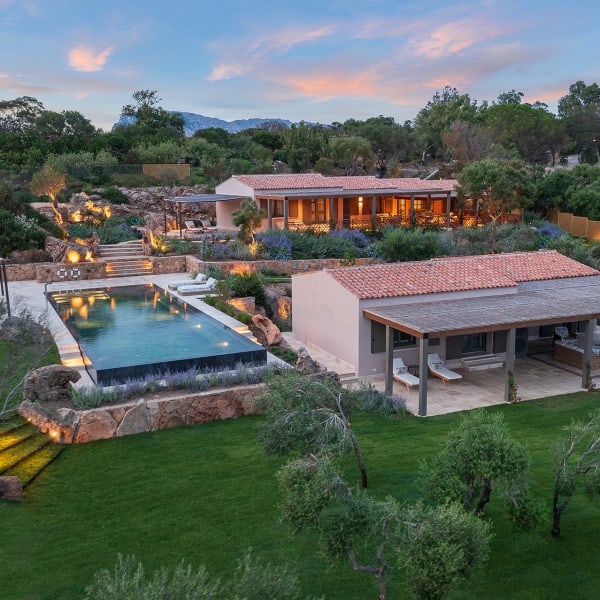 The main house, guesthouse and infinity pool of Salinedda Six are enveloped in manicured gardens.