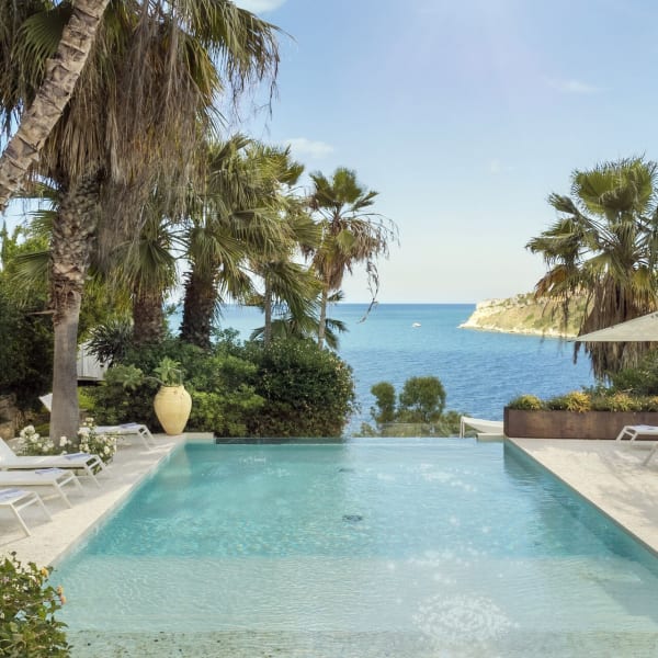 Relaxing by Baia dei Turchi's beautiful infinity pool.