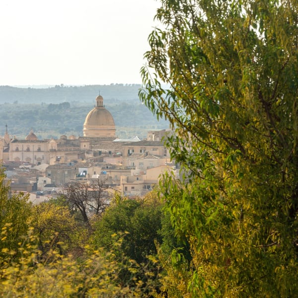 The magnificent dome of Noto's cathedral seen from near the pool.