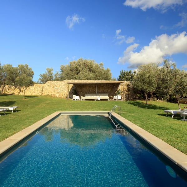 The cobalt blue pool surrounded by emerald green lawns.