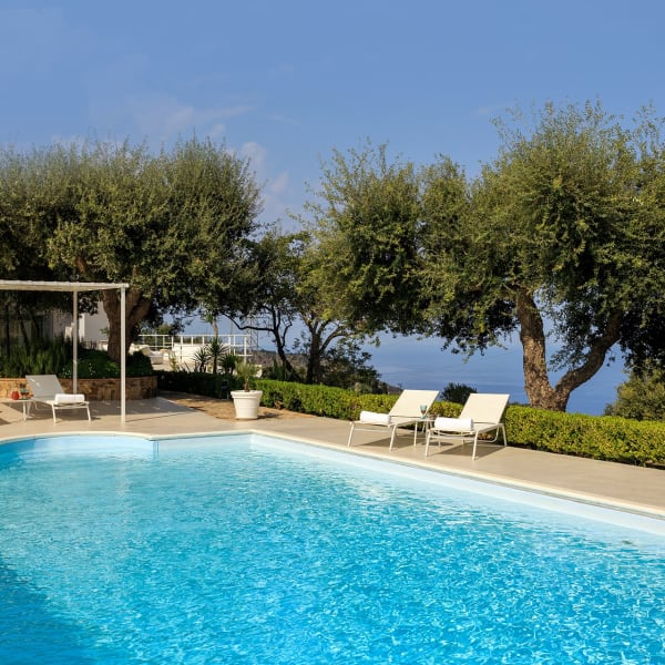 The panoramic, olive tree-flanked pool has mountain and sea views.