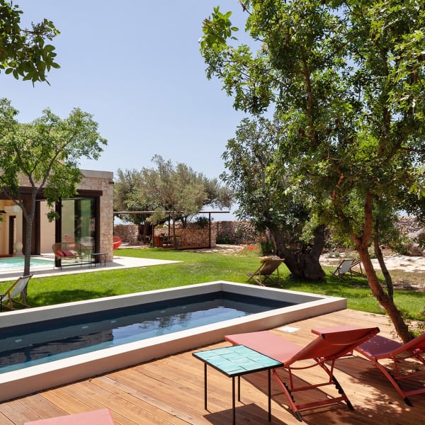 The house and gardens seen from by the pool.