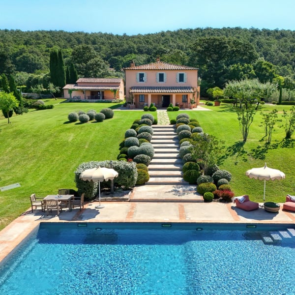 Casalberna rising handsomely above its gardens and pool.