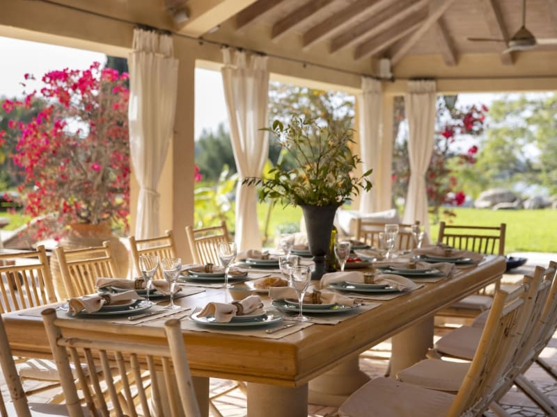 The main al fresco dining area is located in a voluminous pergola near the pool.