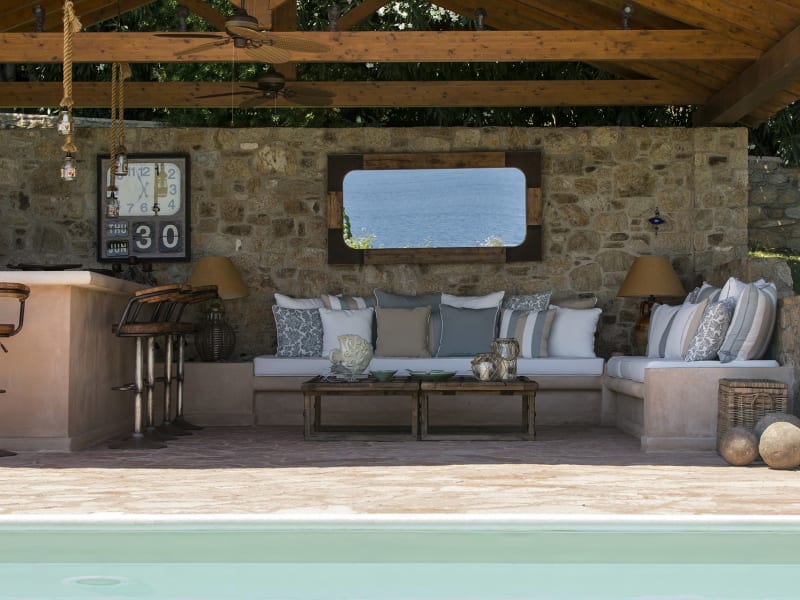 The shady poolside pavilion with its comfy seating and bar.