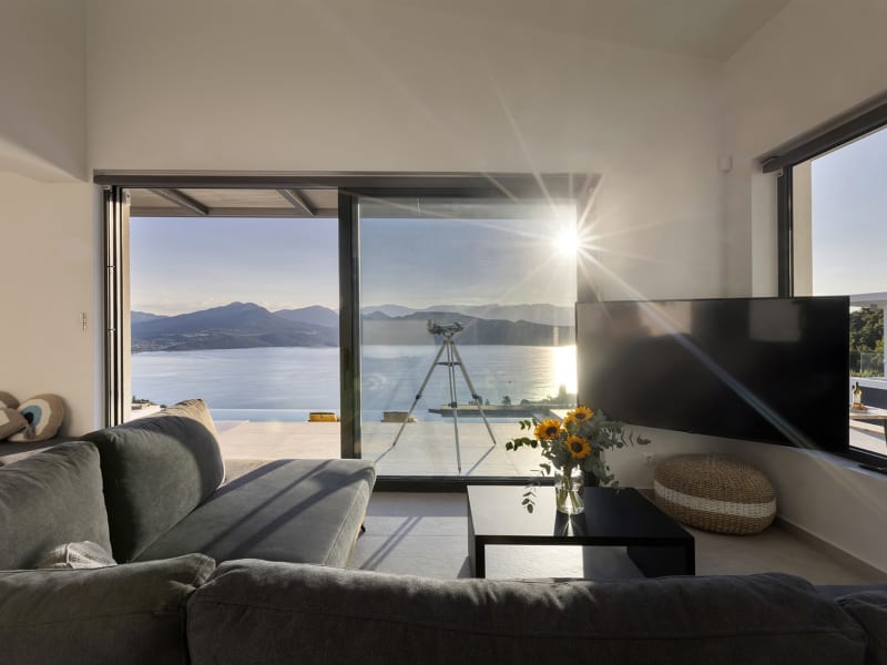The living area in the open-concept communal space with its wide sliding glass doors.