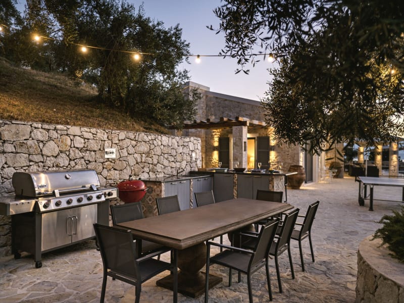 The second al fresco dining area is served by an outdoor kitchen and bar.
