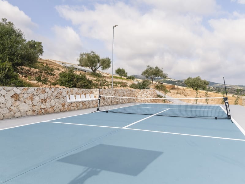 A mini tennis court with basketball hoop is perfect for sports lovers.