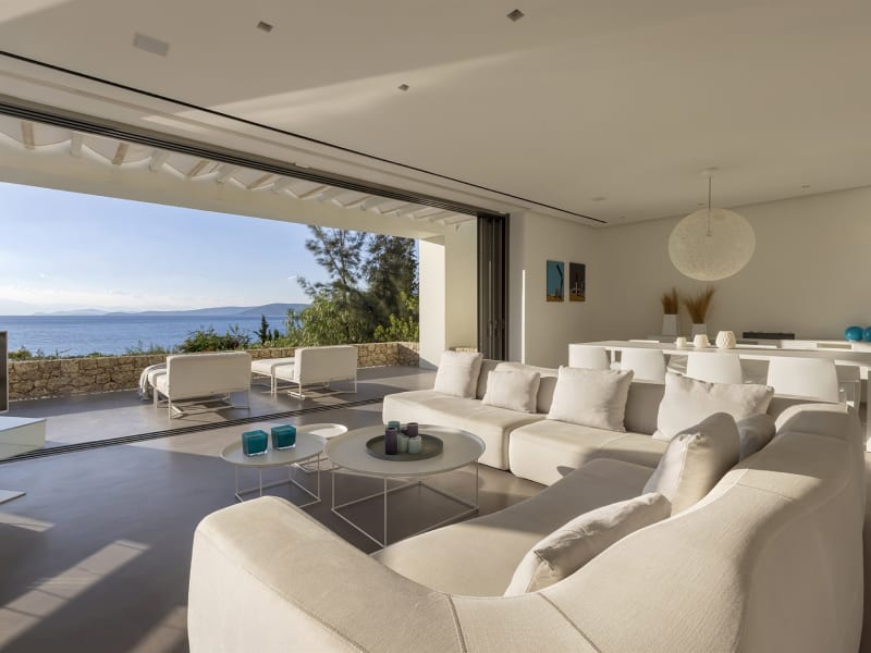 The living and dining area with its fully retractable sliding glass walls.