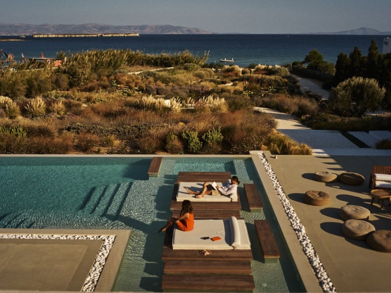 Santhia's "floating" wooden daybeds in the shallow end of the pool, and the views out to sea.