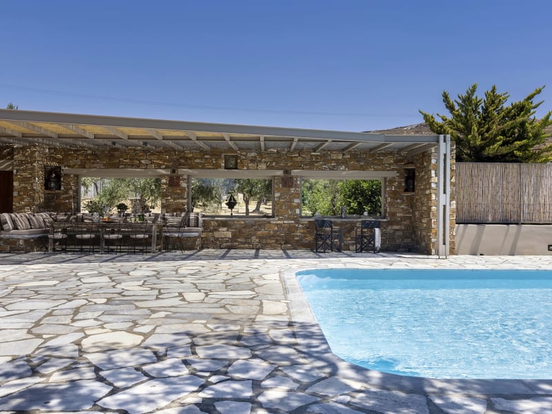 The shaded sitting and dining area by the pool.