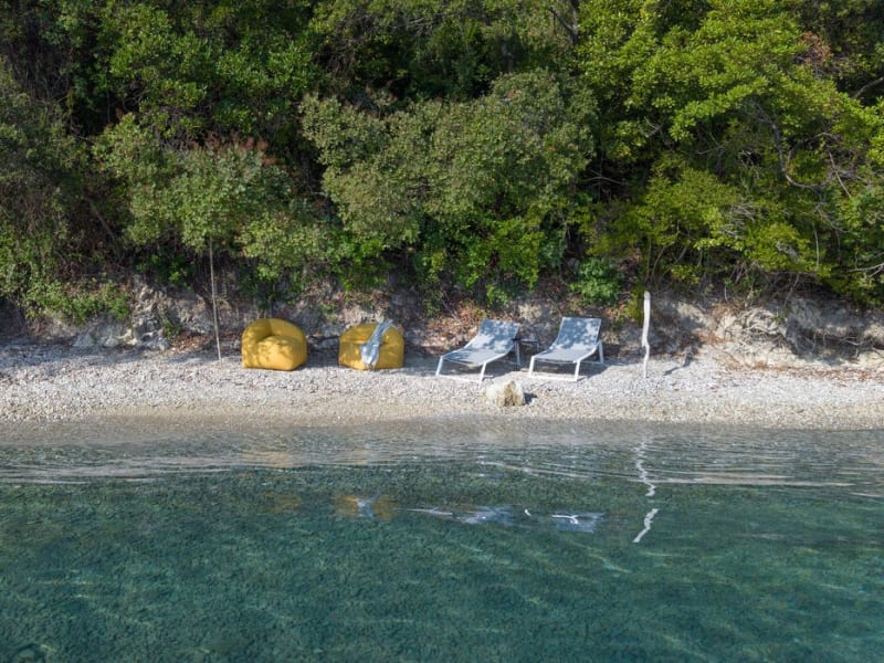 The idyllic little pebbly beach below Villa Naia.