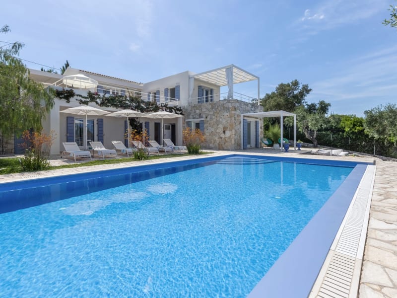 Villa Stella rising handsomely above its zero-edge pool.